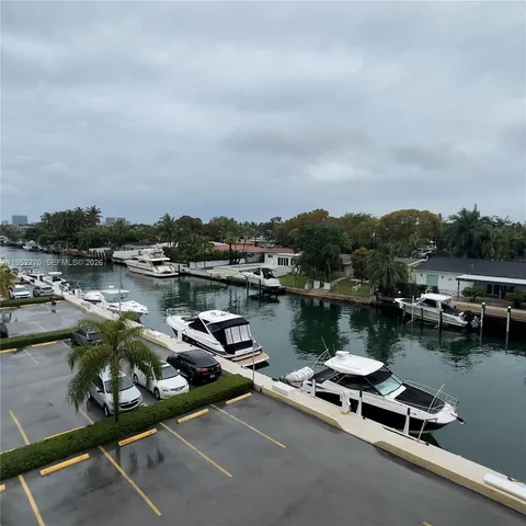a view of a lake with boats and trees in the background