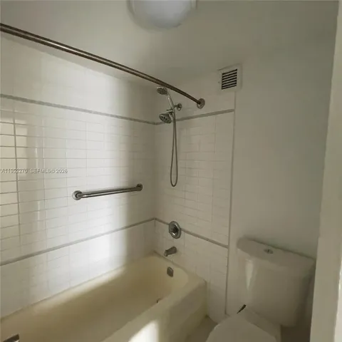 a bathroom with a shower and a bath tub