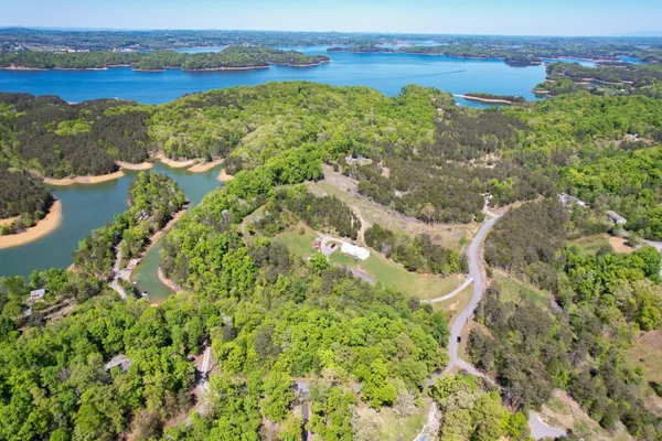 an aerial view of a houses with a lake