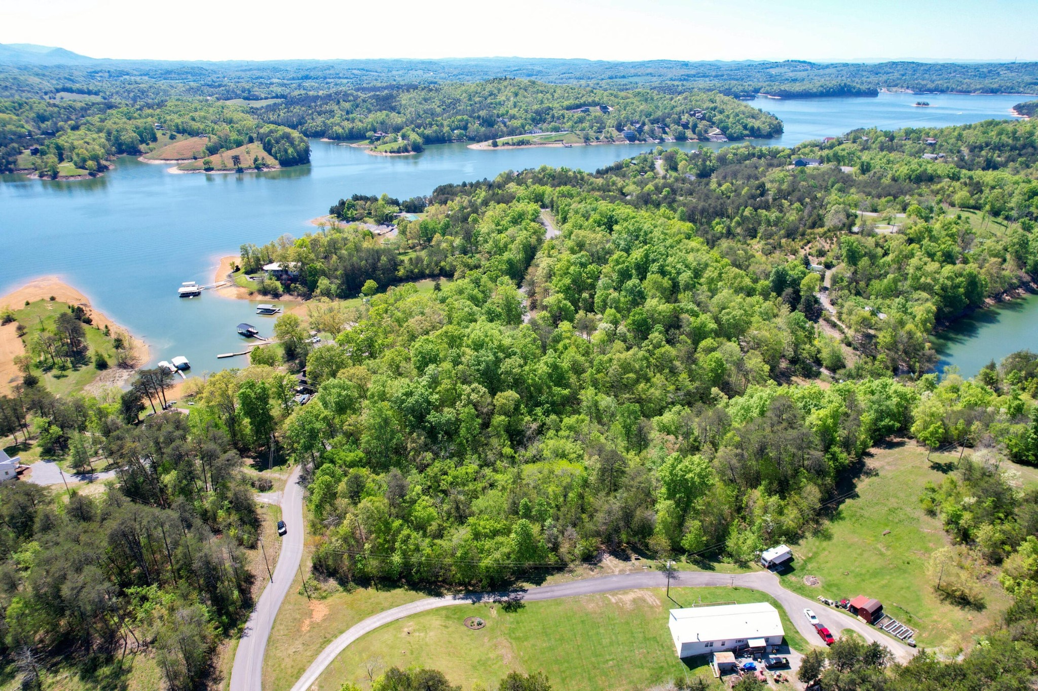 13 Pleasure Road Sevierville, TN 37876 - Photo 5 of 20 an aerial view of green landscape with trees houses and lake view