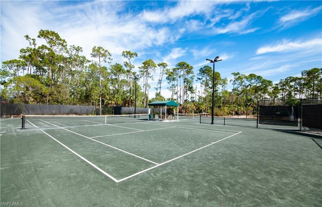 4960 Deerfield Way, Unit E102 Naples, FL 34110 - Photo 17 of 19 a view of a tennis court