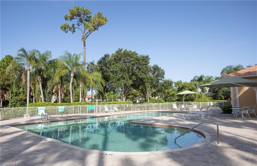 4960 Deerfield Way, Unit E102 Naples, FL 34110 - Photo 19 of 19 a view of a swimming pool with a patio