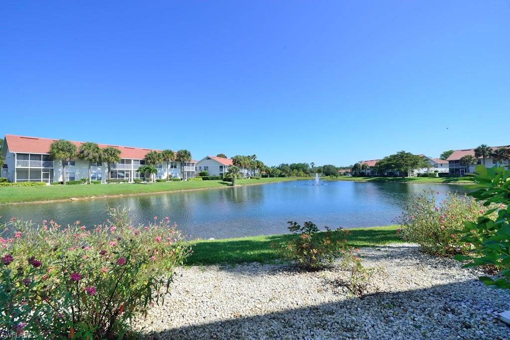 4960 Deerfield Way, Unit E102 Naples, FL 34110 - Photo 3 of 19 a view of a lake with a big yard