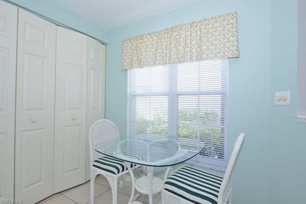 4960 Deerfield Way, Unit E102 Naples, FL 34110 - Photo 10 of 19 a view of a room that has a table and chair