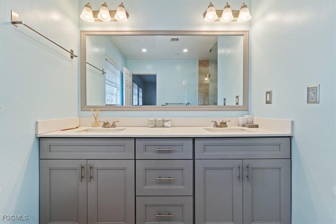 610 East Avenida Del Rio Clewiston, FL 33440 - Photo 40 of 49 a bathroom with a sink vanity and mirror