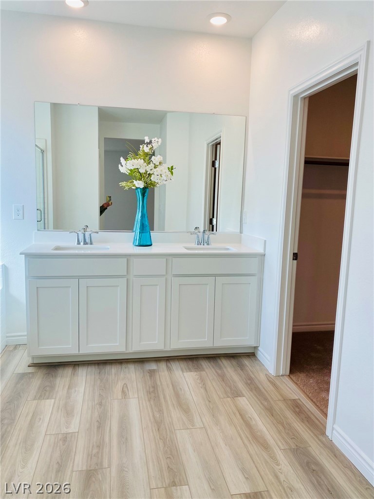 4457 Sawyer Ridge Street Las Vegas, NV 89147 - Photo 27 of 32 This spacious bathroom features a large vanity with ample storage and sleek, modern finishes.