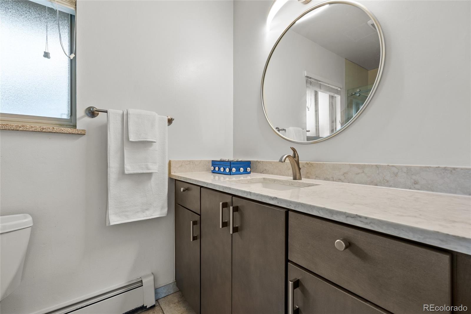 1131 Birdie Road Broomfield, CO 80020 - Photo 17 of 43 a bathroom with a sink a mirror and vanity
