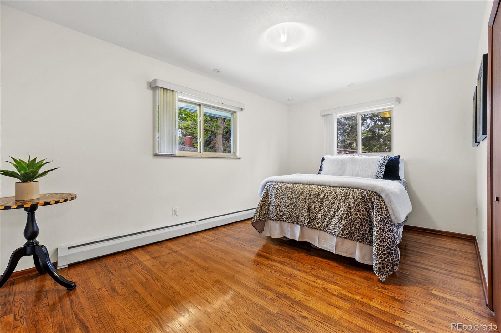 1131 Birdie Road Broomfield, CO 80020 - Photo 19 of 43 a bedroom with a bed and painting on the wall
