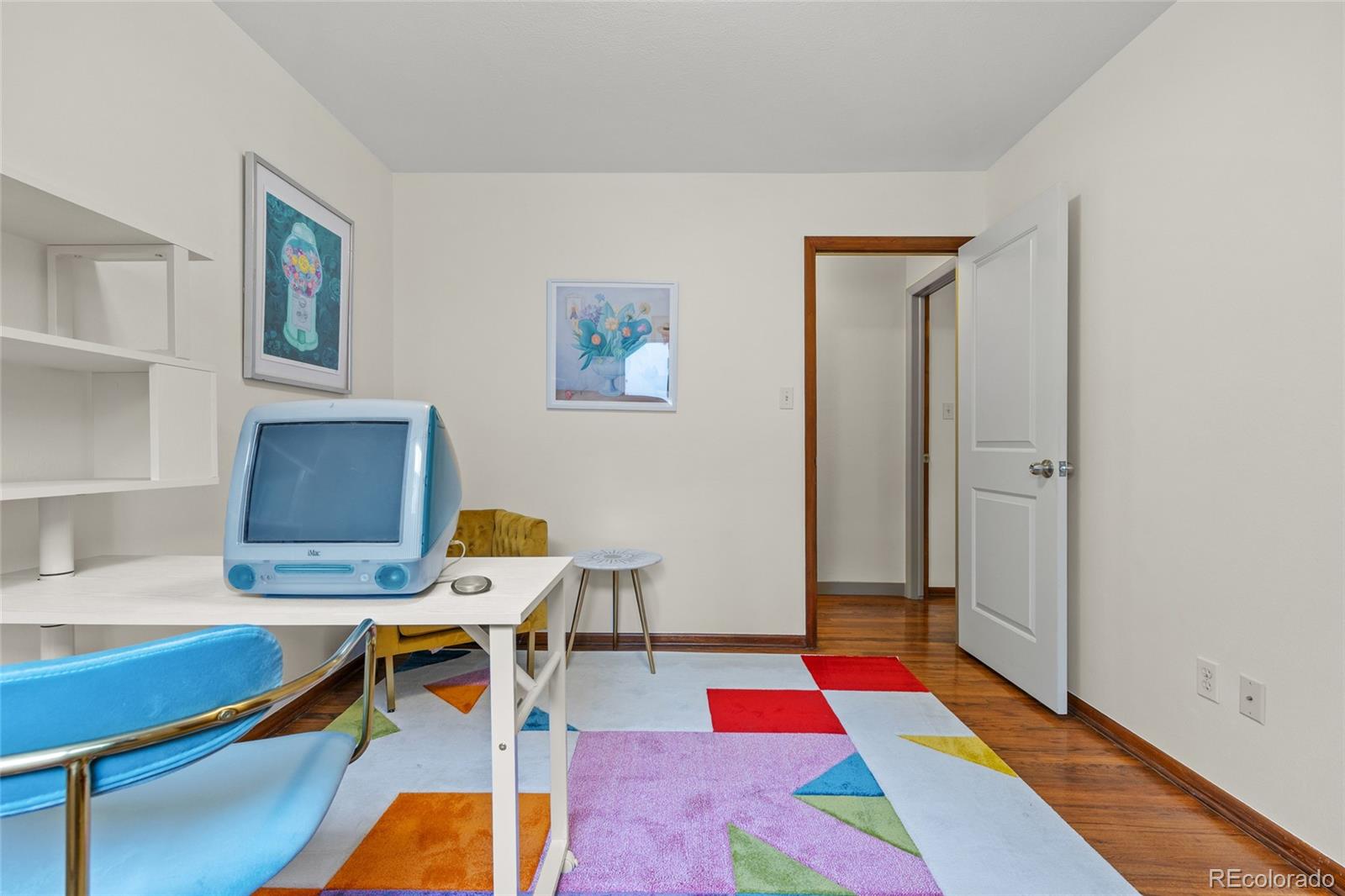 1131 Birdie Road Broomfield, CO 80020 - Photo 24 of 43 a living room with furniture and paintings on the wall