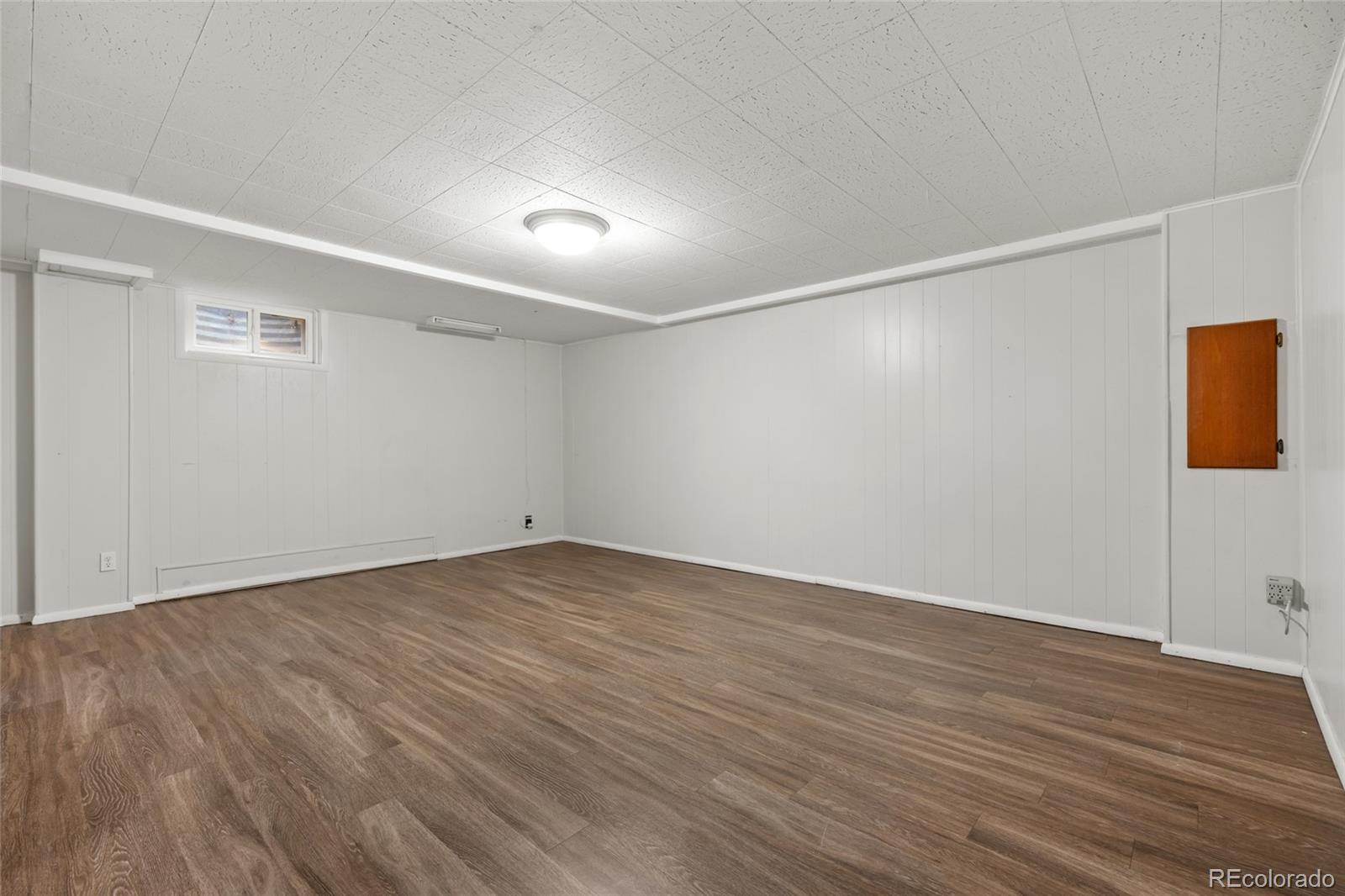 1131 Birdie Road Broomfield, CO 80020 - Photo 27 of 43 a view of an empty room with wooden floor