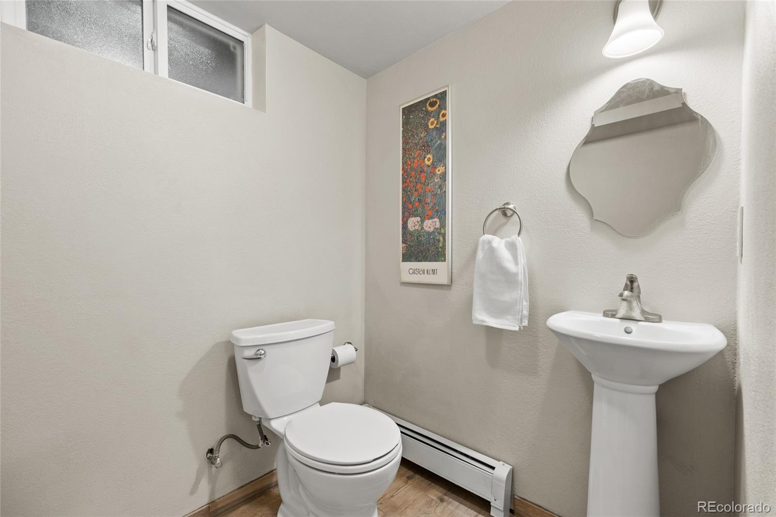 1131 Birdie Road Broomfield, CO 80020 - Photo 28 of 43 a bathroom with a toilet sink and mirror