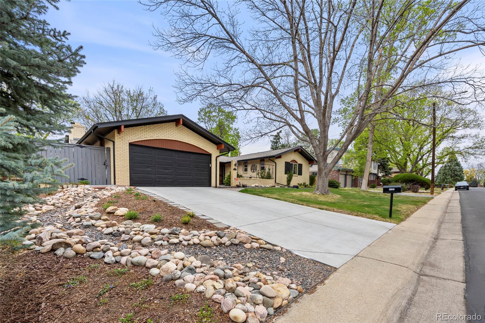 1131 Birdie Road Broomfield, CO 80020 - Photo 43 of 43 a front view of a house with a yard and garage
