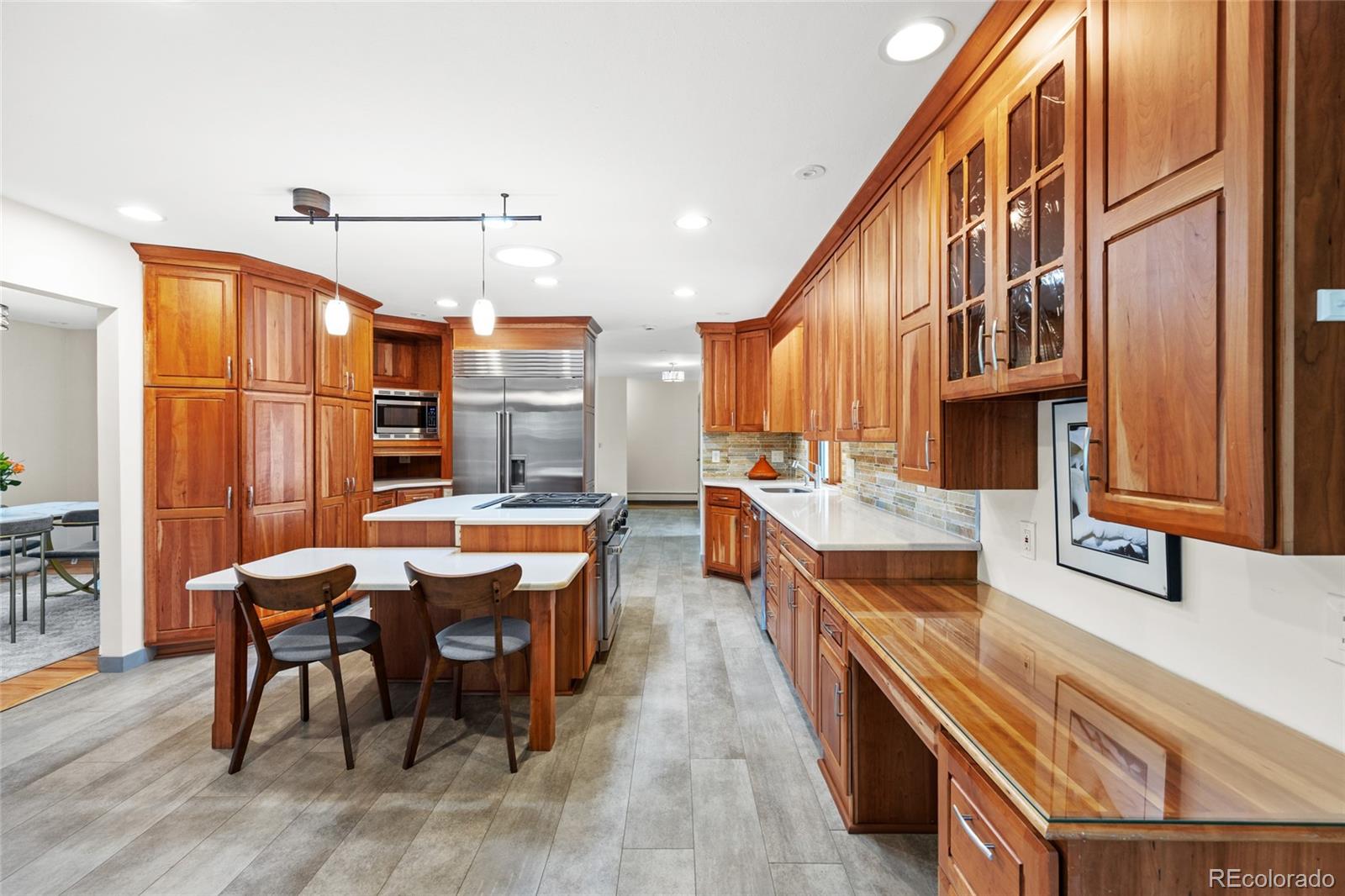 1131 Birdie Road Broomfield, CO 80020 - Photo 6 of 43 a large kitchen with a table and chairs