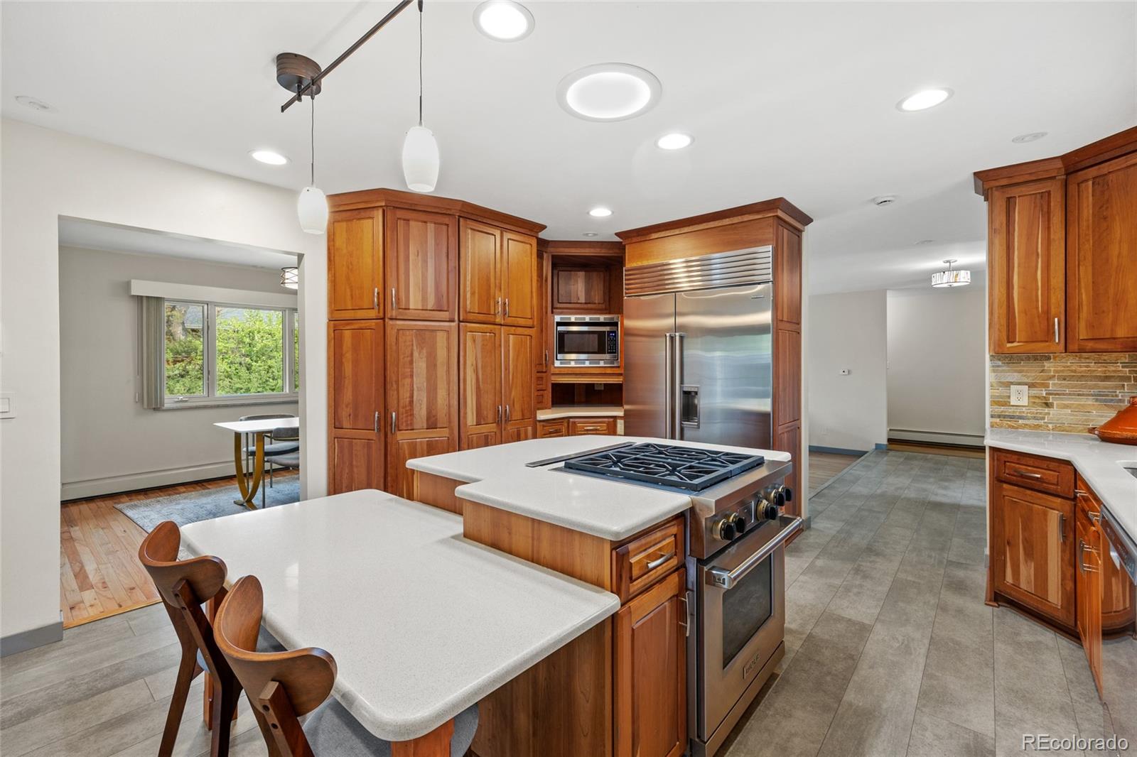 1131 Birdie Road Broomfield, CO 80020 - Photo 8 of 43 a kitchen that has a stove a table and chairs in it