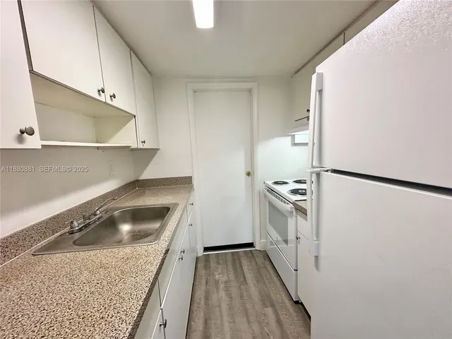 a kitchen with a sink a stove and refrigerator