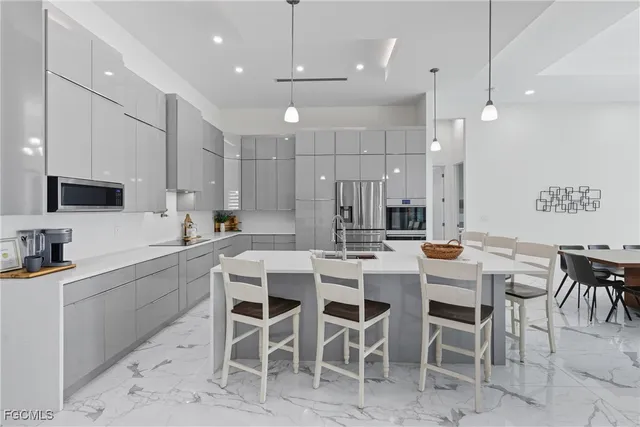 a kitchen with a table chairs refrigerator and microwave