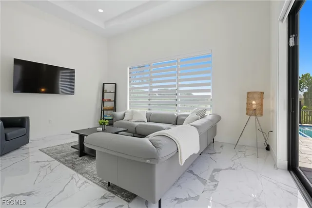 a room with pool table and windows