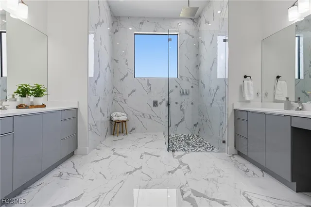 a spacious bedroom with a bed and a chandelier