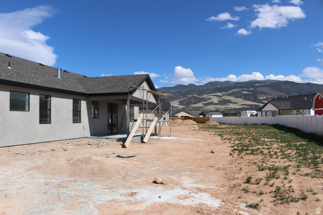 4933 East Remington Road Cedar City, UT 84721 - Photo 27 of 33 Unfinished backyard space featuring a covered patio area, stucco exterior, and a privacy fence