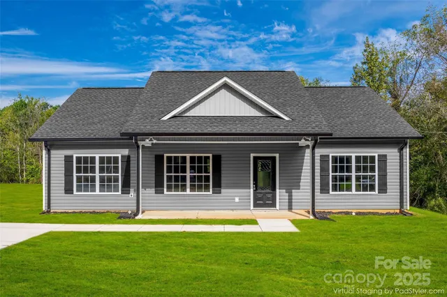 a house that has a big yard with wooden fence