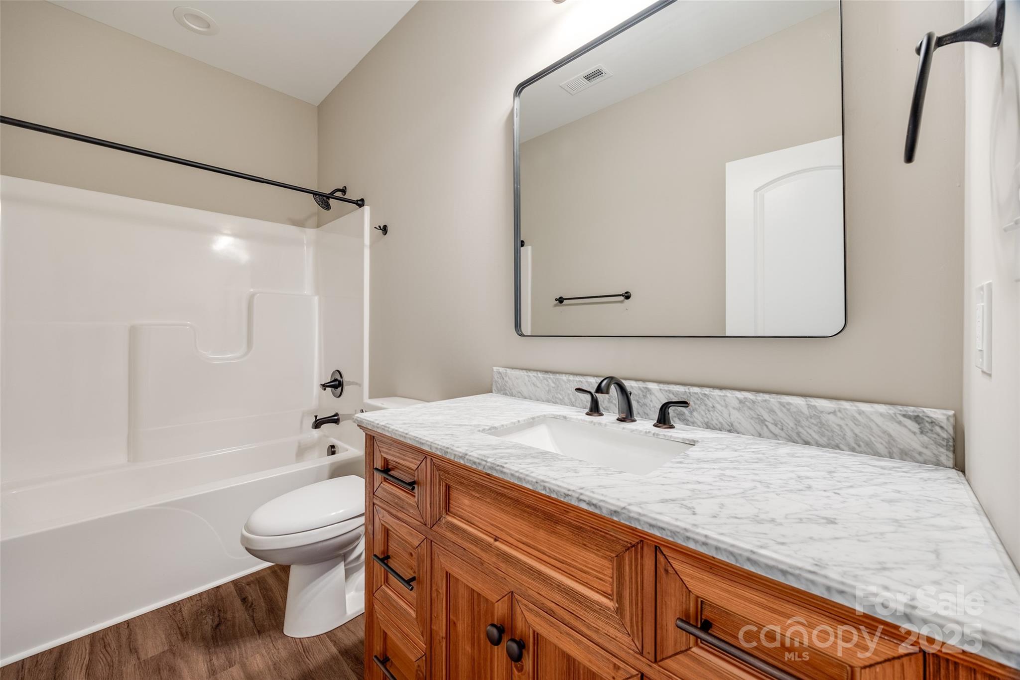 1960 Powell Avenue Lancaster, SC 29720 - Photo 12 of 13 a bathroom with a granite countertop sink mirror toilet and bathtub
