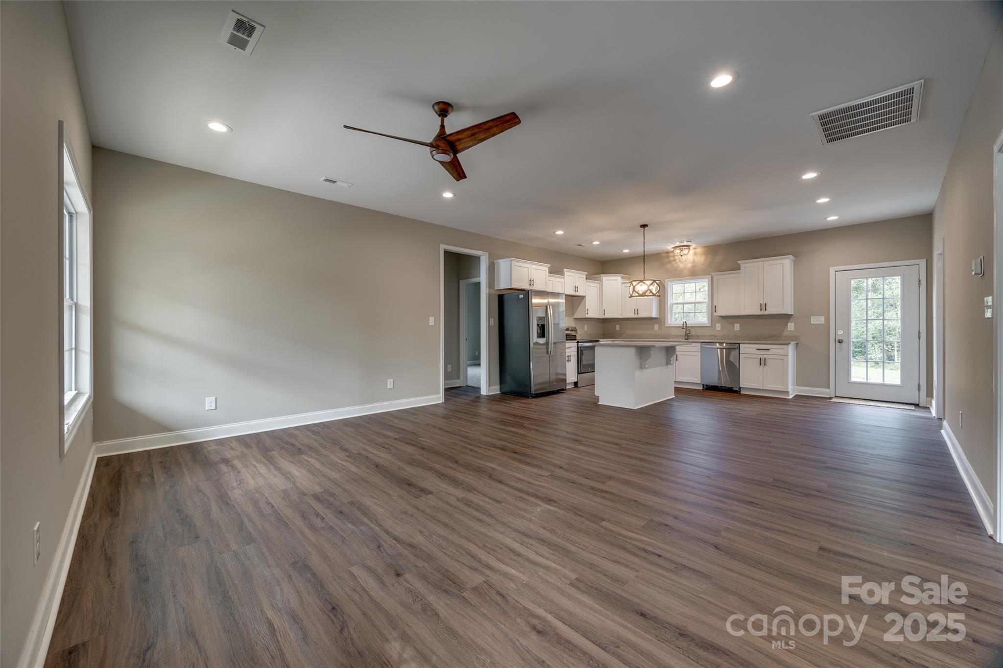 1960 Powell Avenue Lancaster, SC 29720 - Photo 3 of 13 a view of a kitchen with a wooden floor and a kitchen view