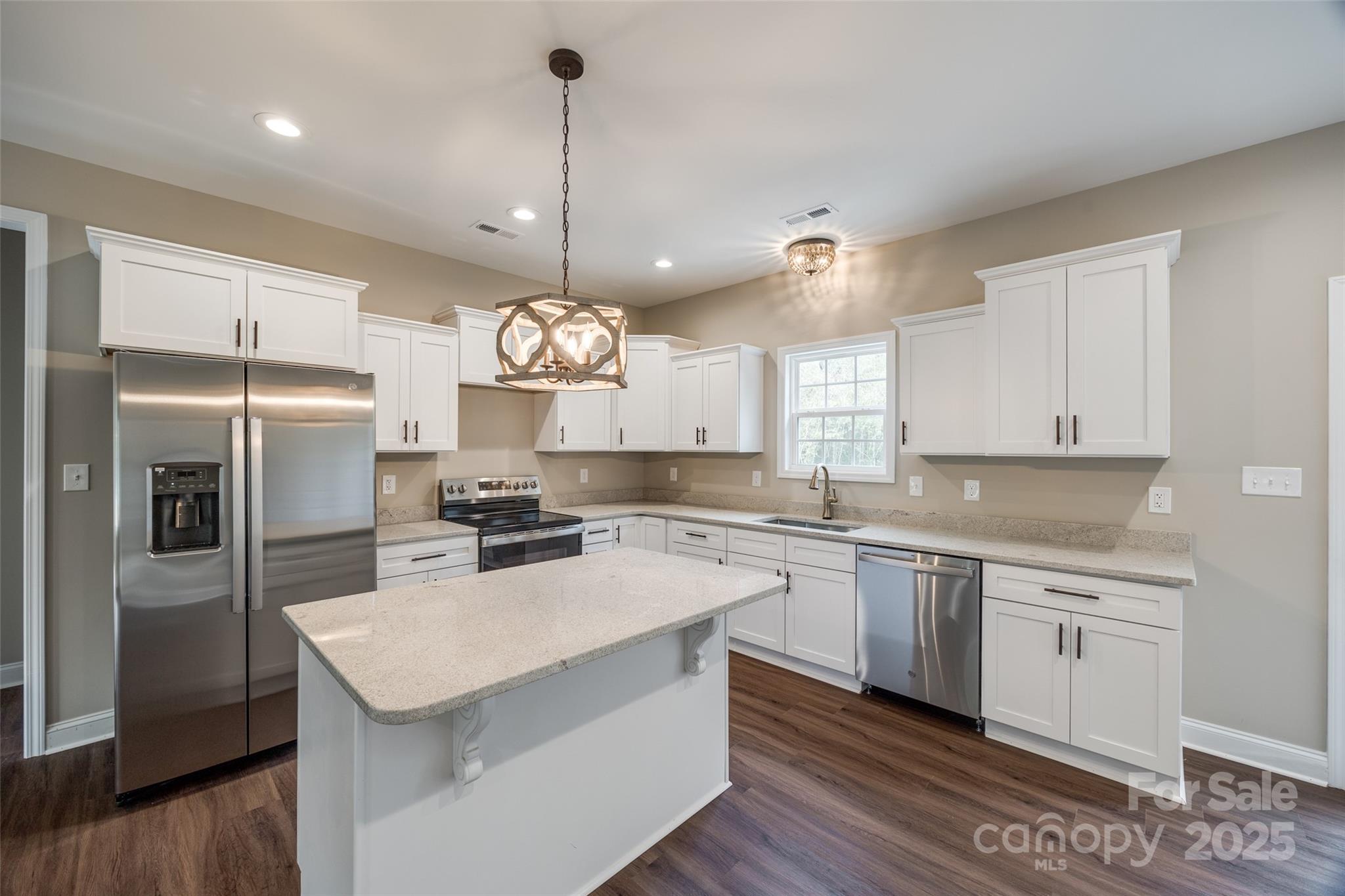 1960 Powell Avenue Lancaster, SC 29720 - Photo 4 of 13 a kitchen with a center island a counter space appliances and cabinets