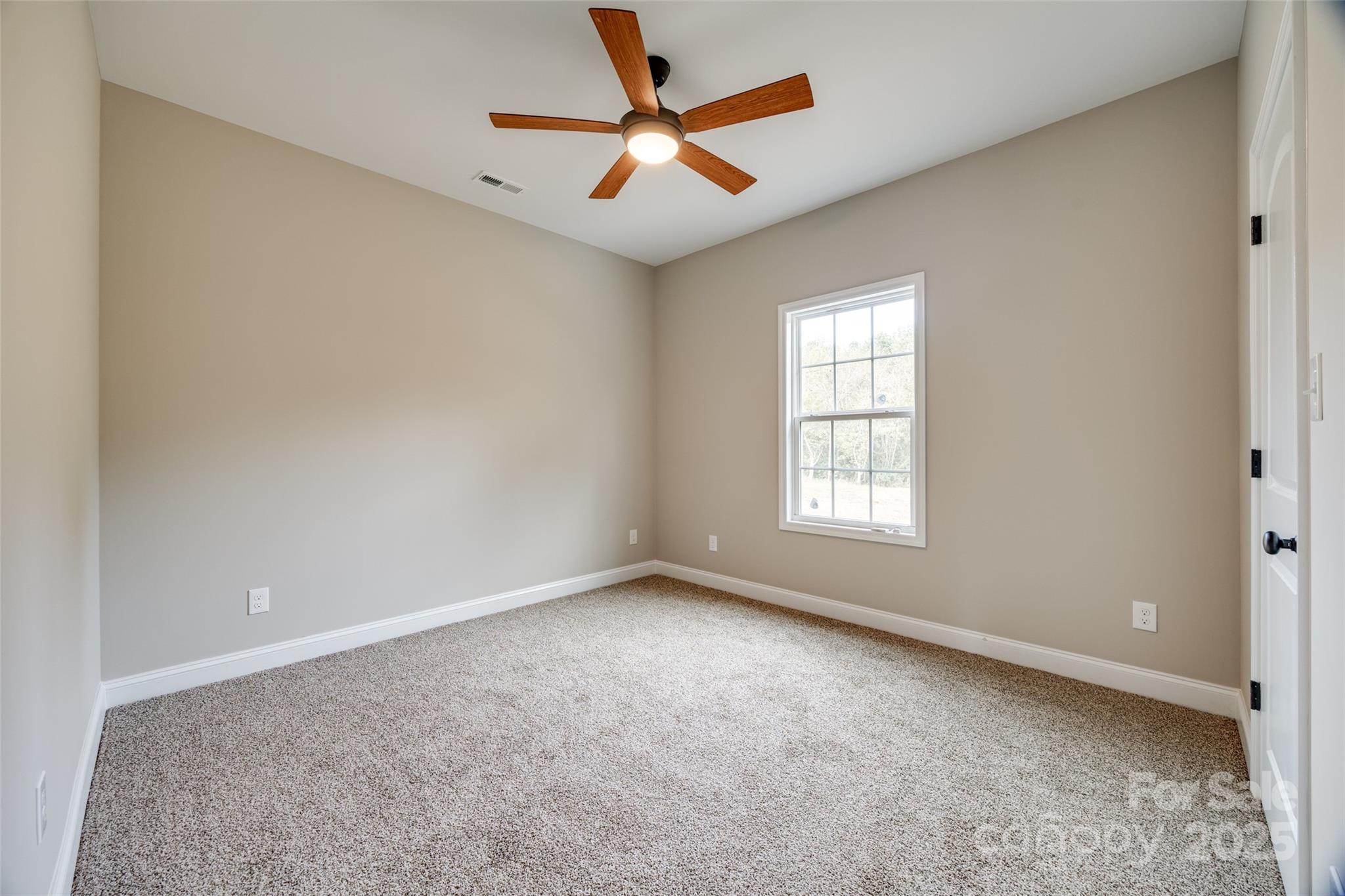 1960 Powell Avenue Lancaster, SC 29720 - Photo 10 of 13 an empty room with windows and fan