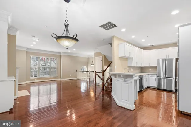 a kitchen with stainless steel appliances a refrigerator sink and stove