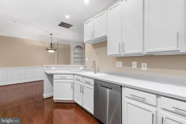 a kitchen with granite countertop a refrigerator stove and microwave