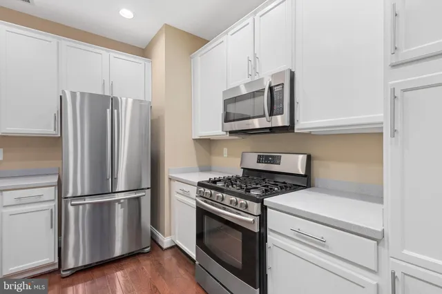 a view of entryway with furniture and wooden floor