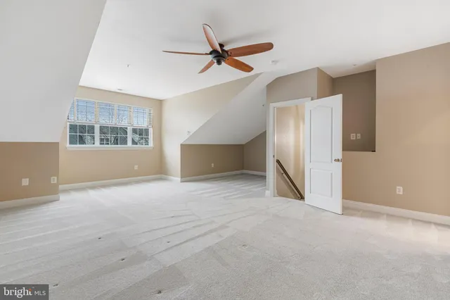 a view of a livingroom with a ceiling fan and window