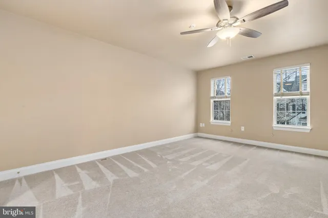 a view of a big room with closet and a chandelier fan