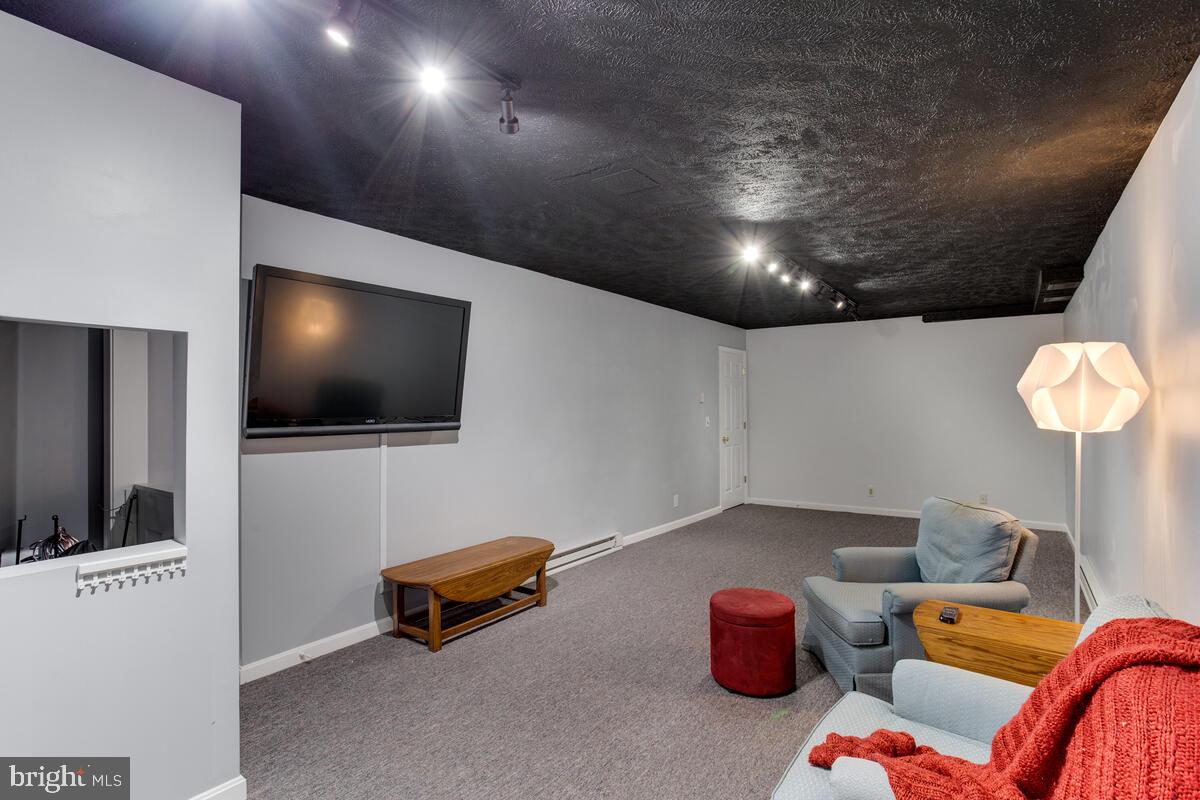 7883 Poplar Grove Road Severn, MD 21144 - Photo 50 of 77 a living room with furniture and a flat screen tv