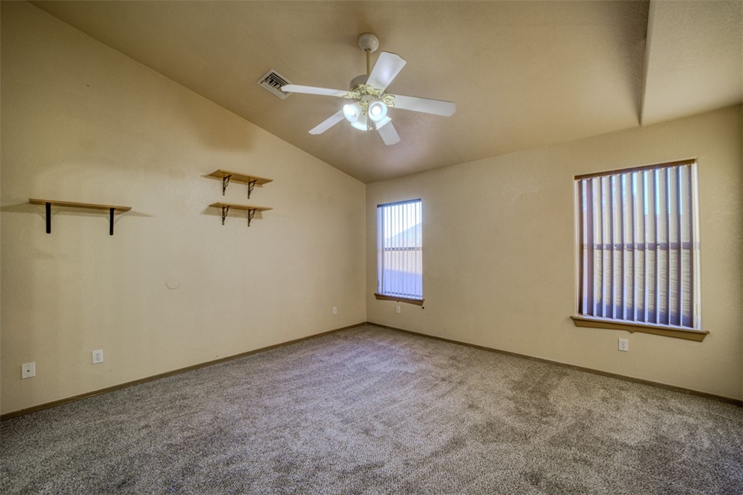 2213 Jamie Road Fort Mohave, AZ 86426 - Photo 15 of 51 Carpeted spare room with lofted ceiling and a ceiling fan