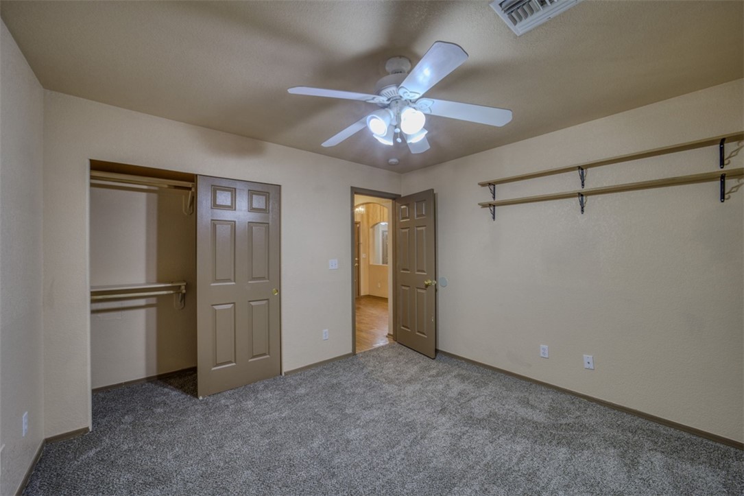 2213 Jamie Road Fort Mohave, AZ 86426 - Photo 20 of 51 Unfurnished bedroom featuring a closet, carpet, and ceiling fan