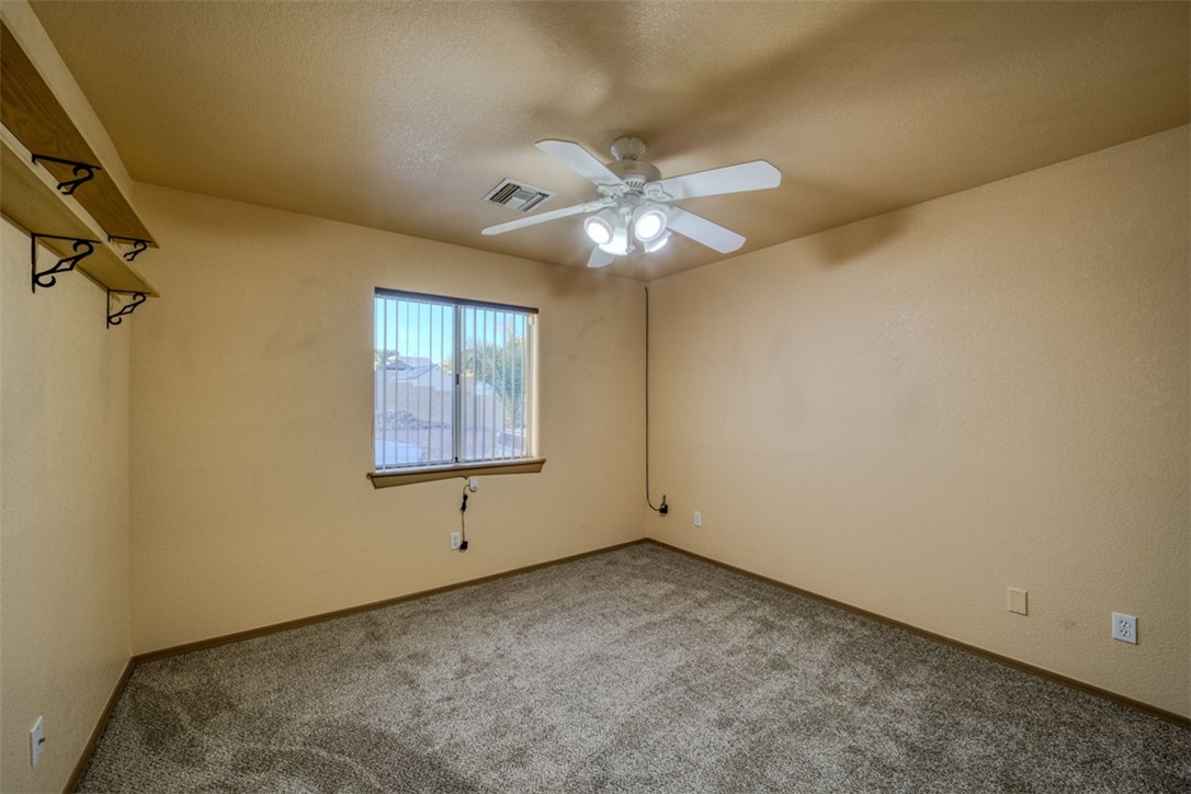 2213 Jamie Road Fort Mohave, AZ 86426 - Photo 21 of 51 Carpeted spare room featuring a textured ceiling and ceiling fan