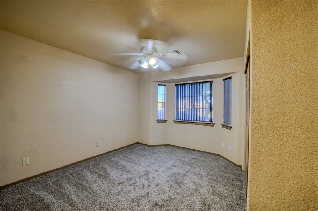 2213 Jamie Road Fort Mohave, AZ 86426 - Photo 23 of 51 Carpeted empty room with a ceiling fan and baseboards