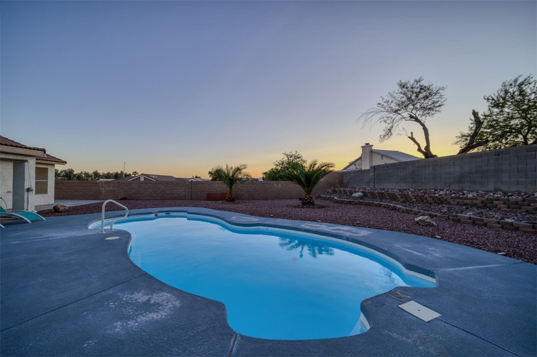 2213 Jamie Road Fort Mohave, AZ 86426 - Photo 32 of 51 Pool at dusk with a fenced backyard and a patio