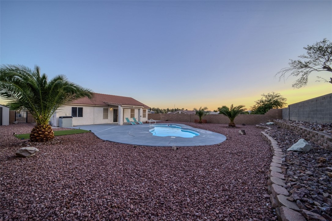 2213 Jamie Road Fort Mohave, AZ 86426 - Photo 33 of 51 Pool at dusk featuring a fenced backyard and a patio area