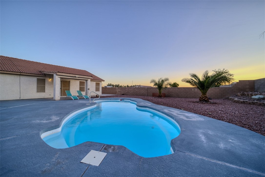 2213 Jamie Road Fort Mohave, AZ 86426 - Photo 34 of 51 Pool at dusk with a patio and a fenced backyard