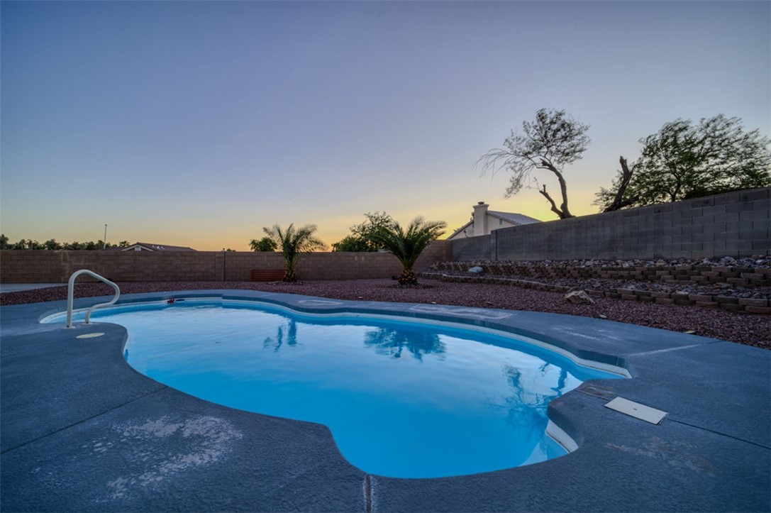2213 Jamie Road Fort Mohave, AZ 86426 - Photo 35 of 51 Pool at dusk featuring a fenced backyard and a patio