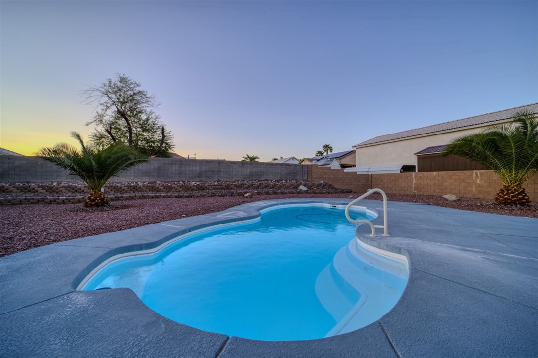 2213 Jamie Road Fort Mohave, AZ 86426 - Photo 36 of 51 Pool at dusk featuring a fenced backyard and a patio area