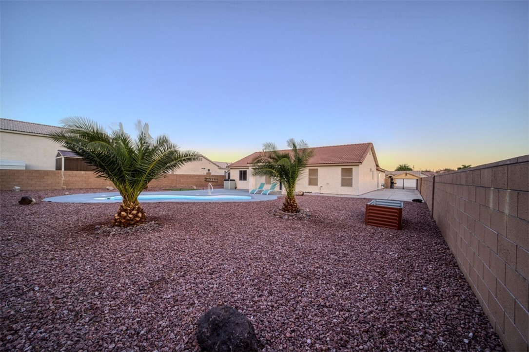 2213 Jamie Road Fort Mohave, AZ 86426 - Photo 40 of 51 Back of property with a fenced backyard, a patio, stucco siding, and a tiled roof