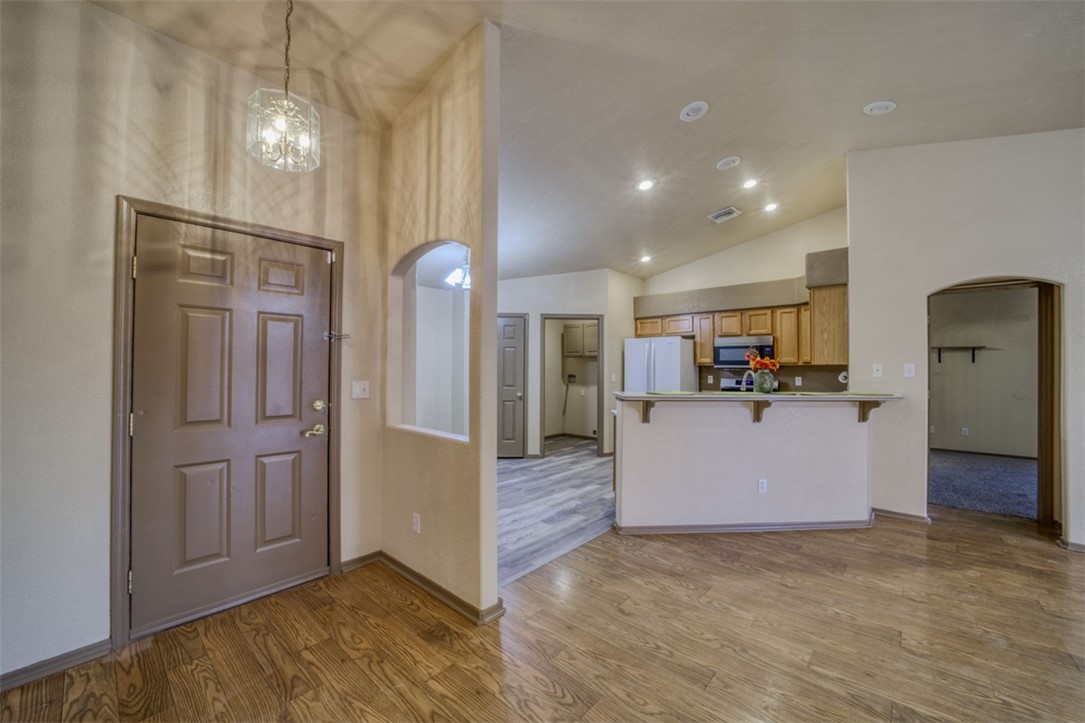 2213 Jamie Road Fort Mohave, AZ 86426 - Photo 4 of 51 Entryway featuring arched walkways, wood finished floors, vaulted ceiling, recessed lighting, and a chandelier