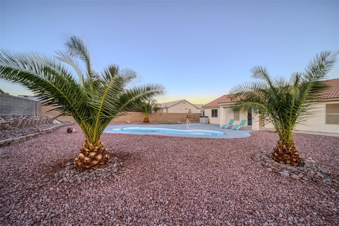 2213 Jamie Road Fort Mohave, AZ 86426 - Photo 41 of 51 Pool at dusk featuring a patio area and a fenced backyard