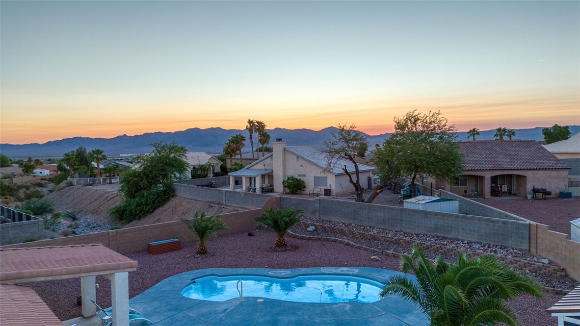 2213 Jamie Road Fort Mohave, AZ 86426 - Photo 47 of 51 Pool at dusk with a fenced backyard and a patio area