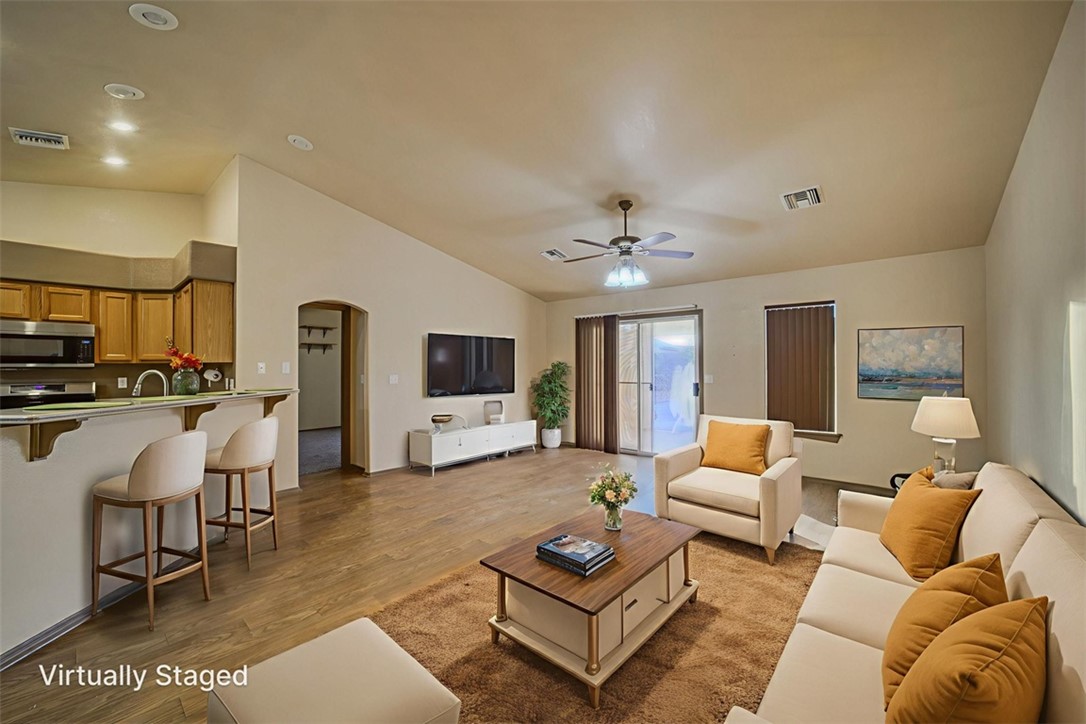 2213 Jamie Road Fort Mohave, AZ 86426 - Photo 9 of 51 Living area with arched walkways, lofted ceiling, light wood-type flooring, and a ceiling fan