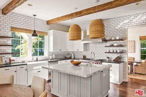 a living room with furniture a potted plant and a fireplace
