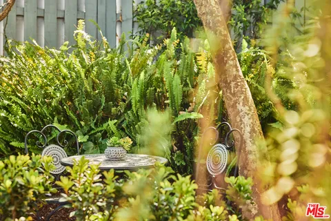 a living room with furniture a fireplace and a chandelier